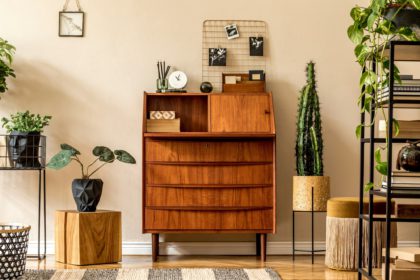 Retro interior design of living room with wooden vintage bureau.