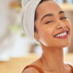 Young hispanic woman with eye mask patches smiling